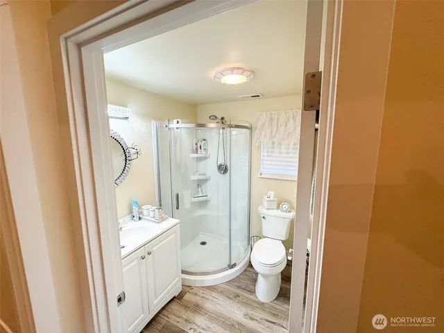 a bathroom with a granite countertop sink toilet and shower