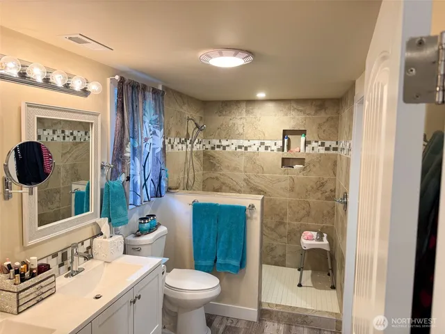 a bathroom with a sink toilet and shower