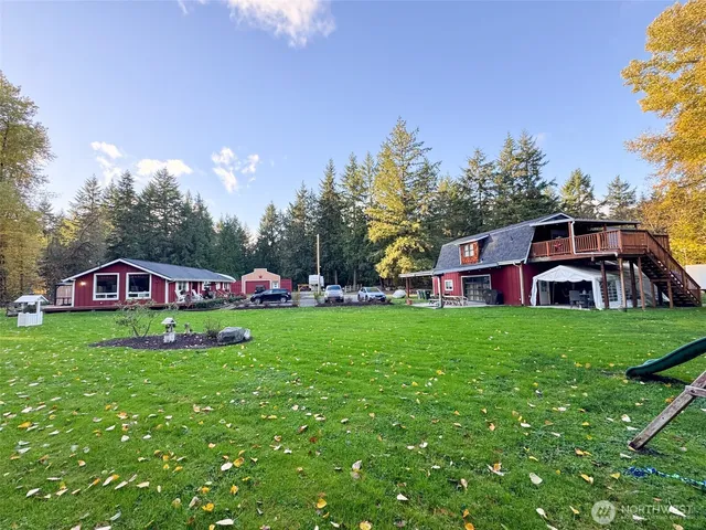 a view of a house with a yard potted plants and a tree