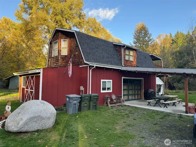a view of backyard of house with outdoor seating and green space