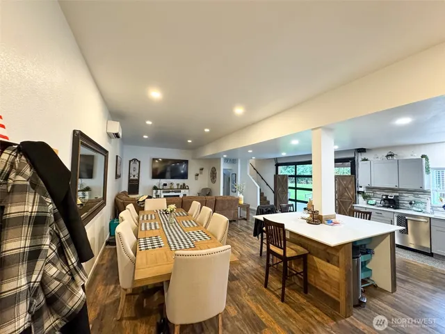a dining room with furniture a rug and wooden floor