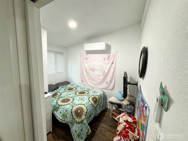 a bedroom with bed and a window