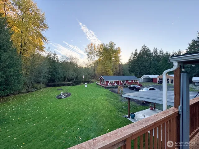 a view of a wooden deck and a yard