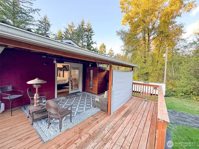 a view of couches on the deck with wooden floor