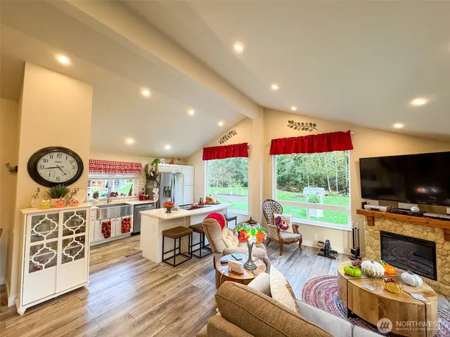 a living room with fireplace furniture and a flat screen tv