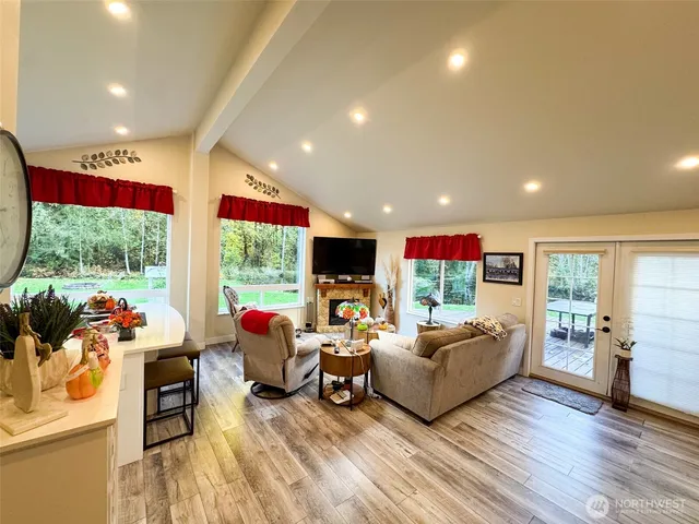a living room with furniture fireplace and flat screen tv