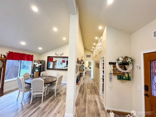 a view of a dining room with furniture and wooden floor