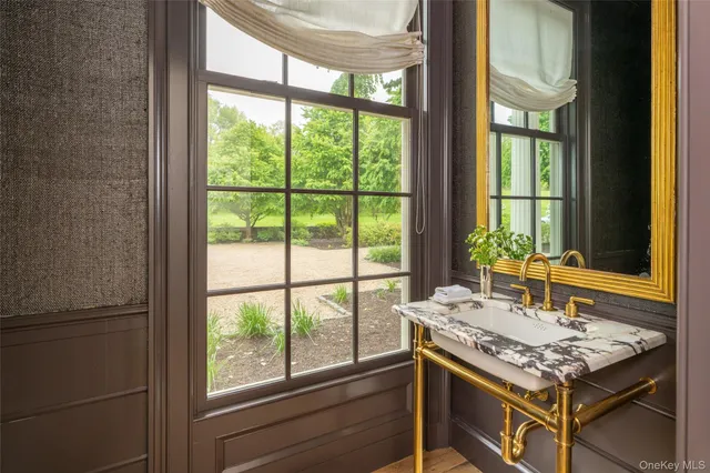 a view of a kitchen island a sink and a large window