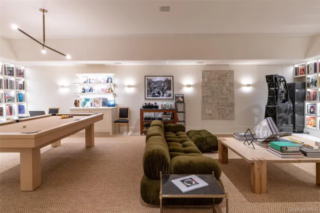 a living room with furniture a air conditioner and a table