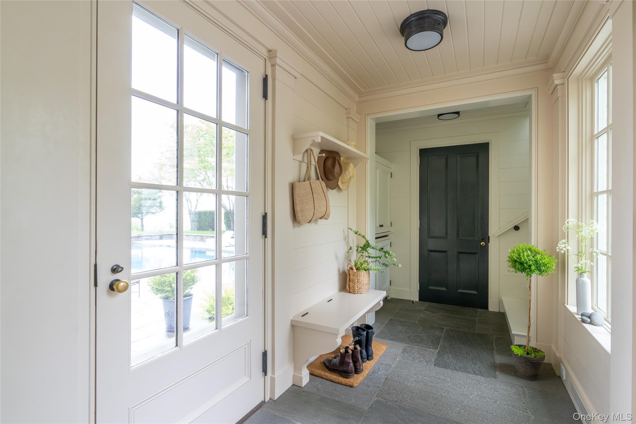 1190 Chestnut Ridge Road Dover Plains, NY 12522 - Photo 32 of 42 Mudroom featuring stone tile flooring, crown molding, and wood ceiling