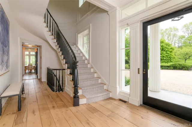 a view of entryway with wooden floor and stairs