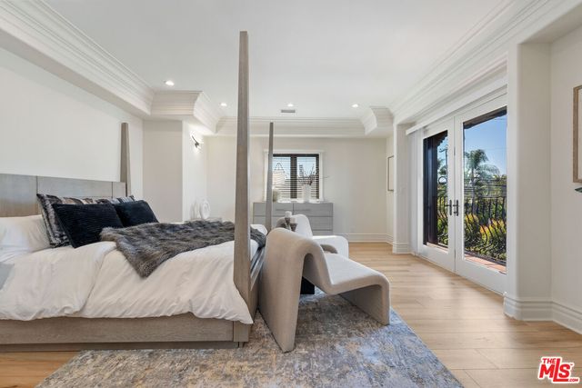 a spacious bedroom with a bed a table and large window