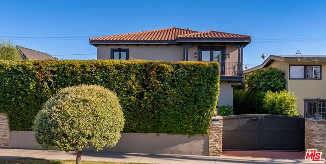 a view of a house with potted plants