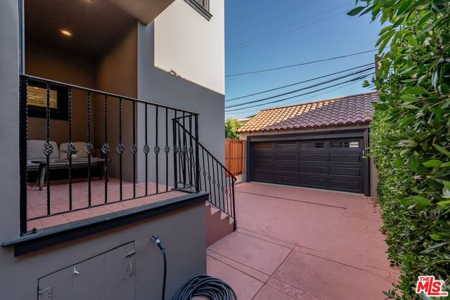 a view of a patio with couches table and chairs and potted plants