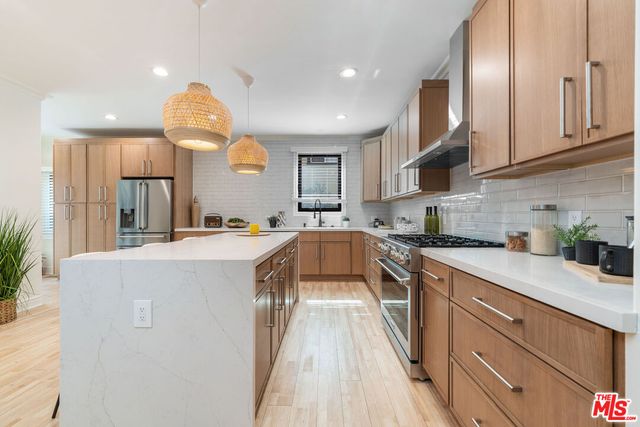 a kitchen with cabinets a sink and appliances