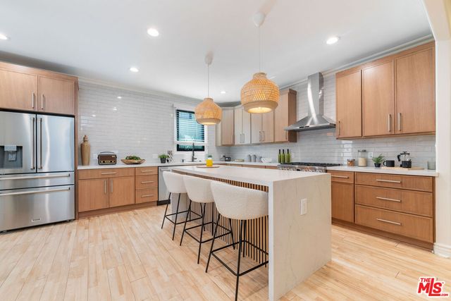 a kitchen with a sink cabinets and wooden floor