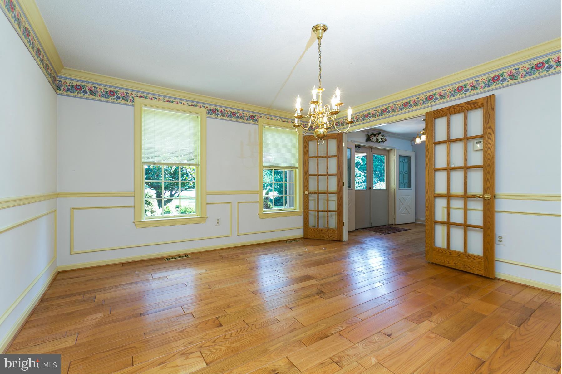 8340 Waverly Road Owings, MD 20736 - Photo 13 of 30 a view of a livingroom with wooden floor and chandelier