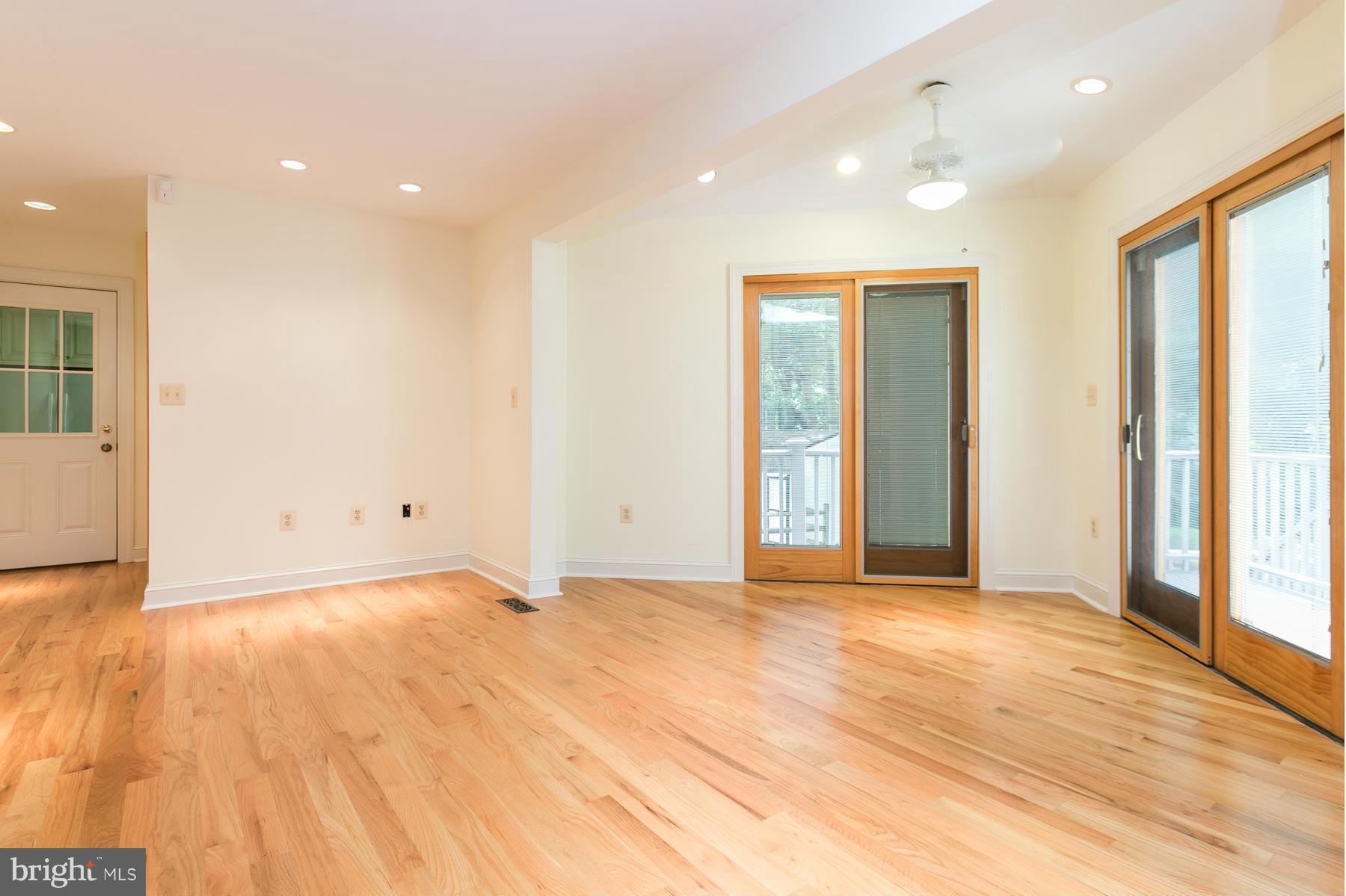 8340 Waverly Road Owings, MD 20736 - Photo 19 of 30 a view of an empty room with wooden floor and windows