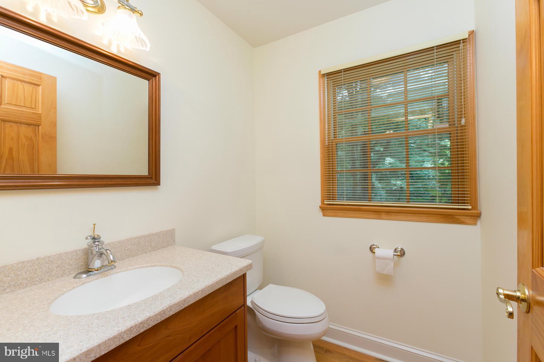 8340 Waverly Road Owings, MD 20736 - Photo 20 of 30 a bathroom with a granite countertop sink toilet and mirror