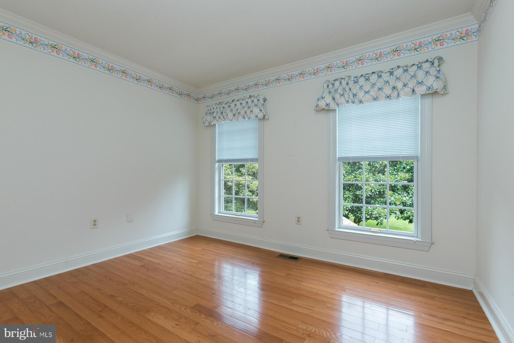 8340 Waverly Road Owings, MD 20736 - Photo 21 of 30 a view of an empty room with wooden floor and a window