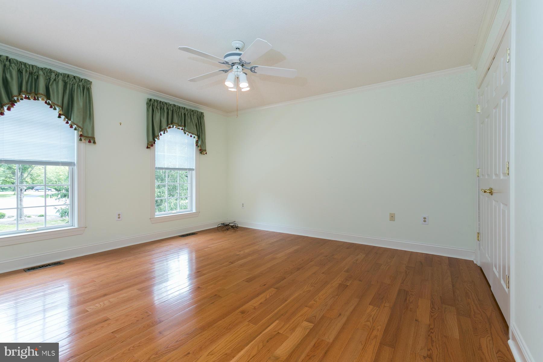 8340 Waverly Road Owings, MD 20736 - Photo 22 of 30 a view of an empty room with wooden floor and a window