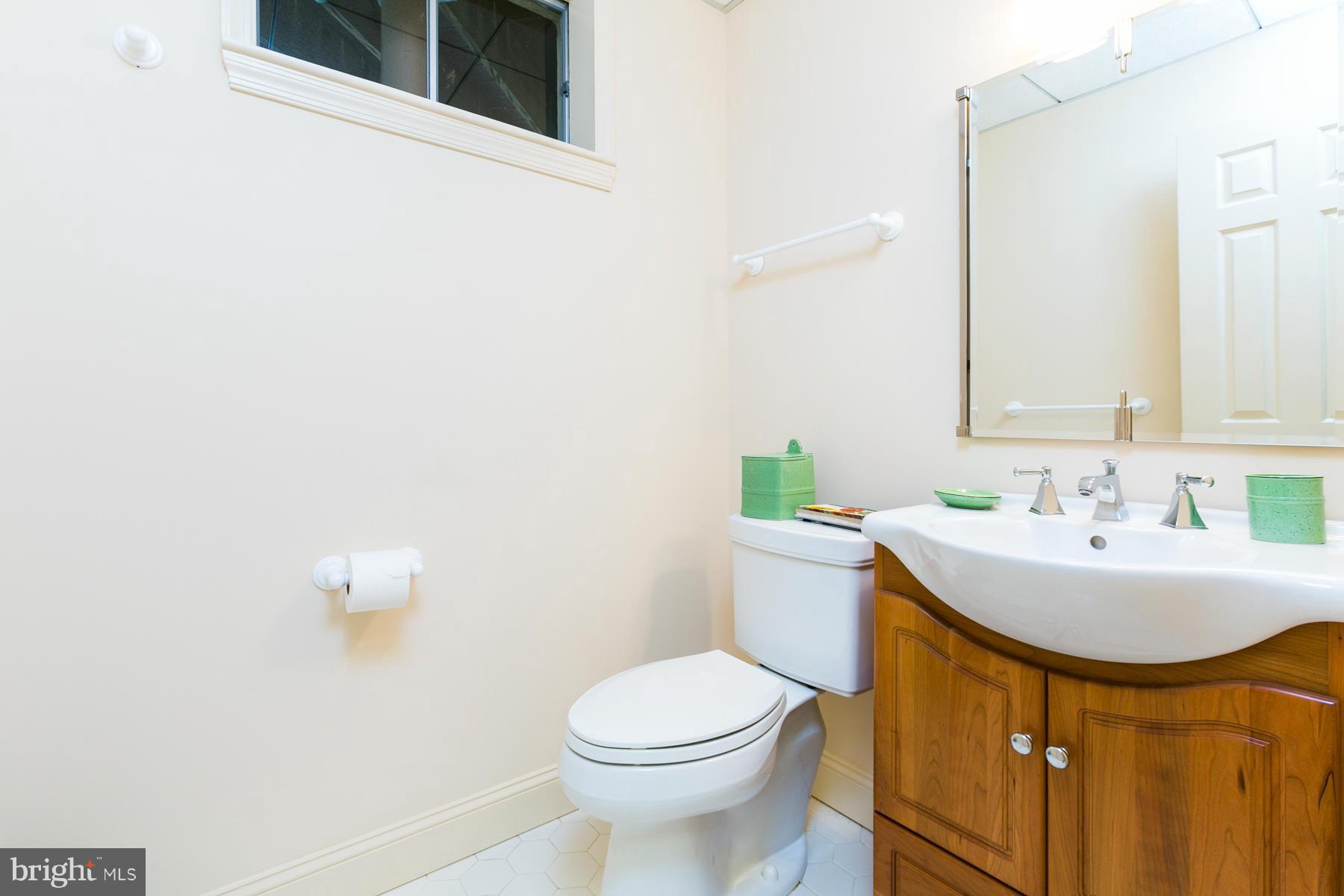 8340 Waverly Road Owings, MD 20736 - Photo 30 of 30 a bathroom with a sink a toilet and mirror