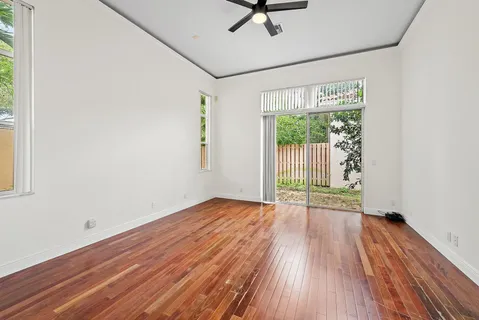 a view of a room with wooden floor and window