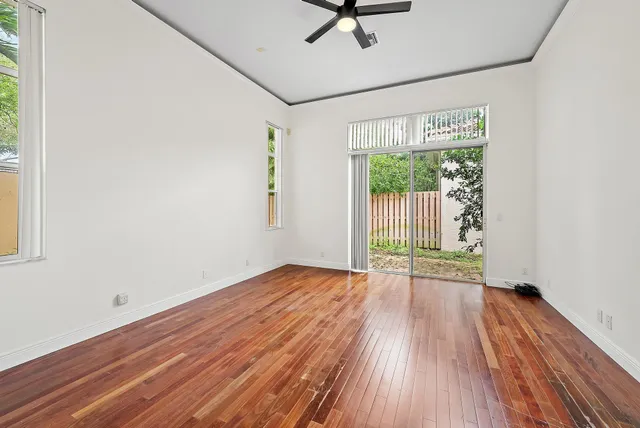 a view of a room with wooden floor and window