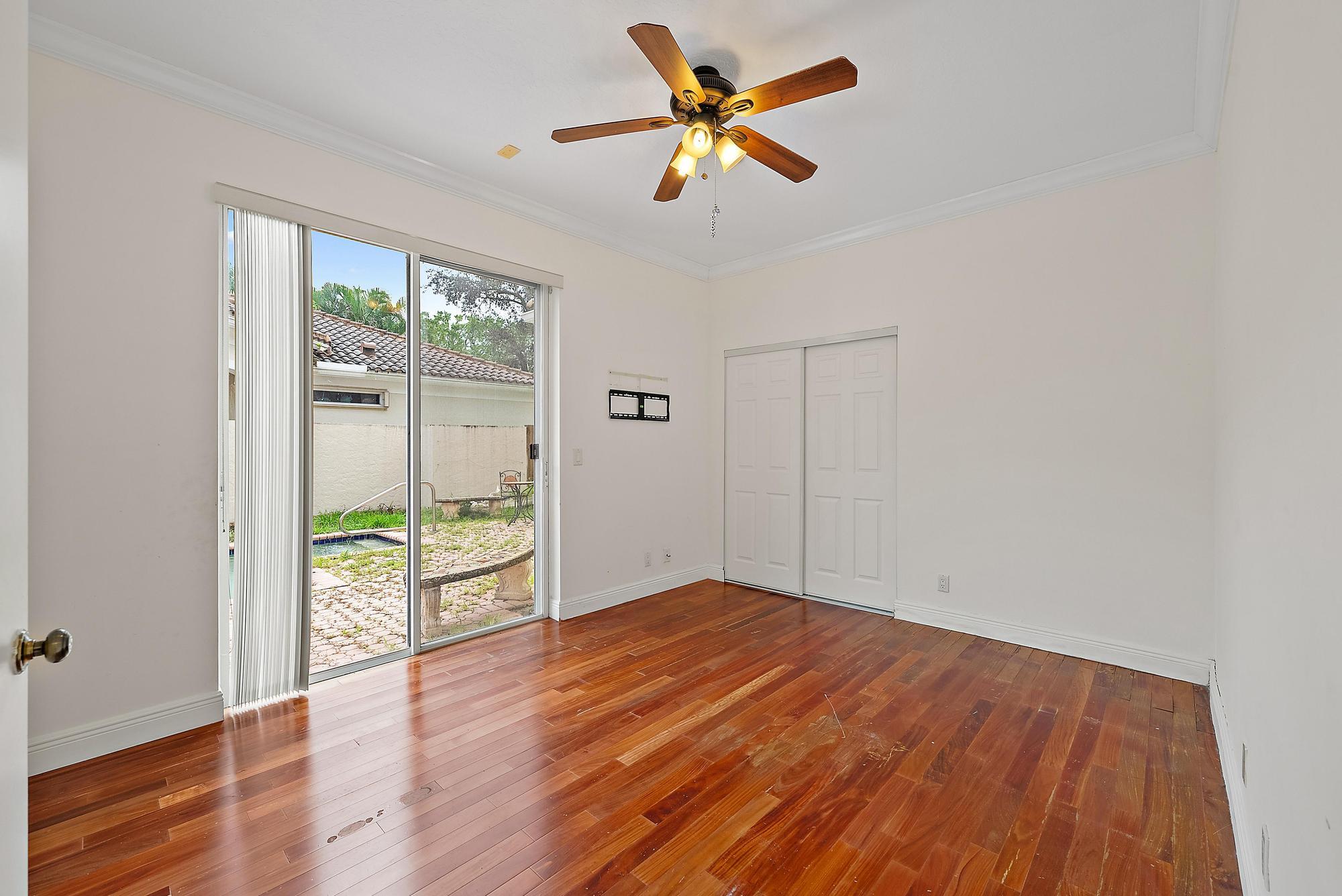 6612 Northwest 23rd Terrace Boca Raton, FL 33496 - Photo 15 of 20 wooden floor in an empty room with a window