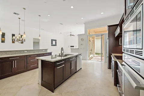 a kitchen with stainless steel appliances granite countertop a stove and a sink