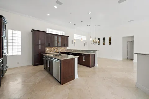 a kitchen with stainless steel appliances granite countertop a stove a sink and a microwave