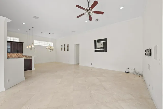 a view of a kitchen with a sink and dishwasher a refrigerator with white cabinets