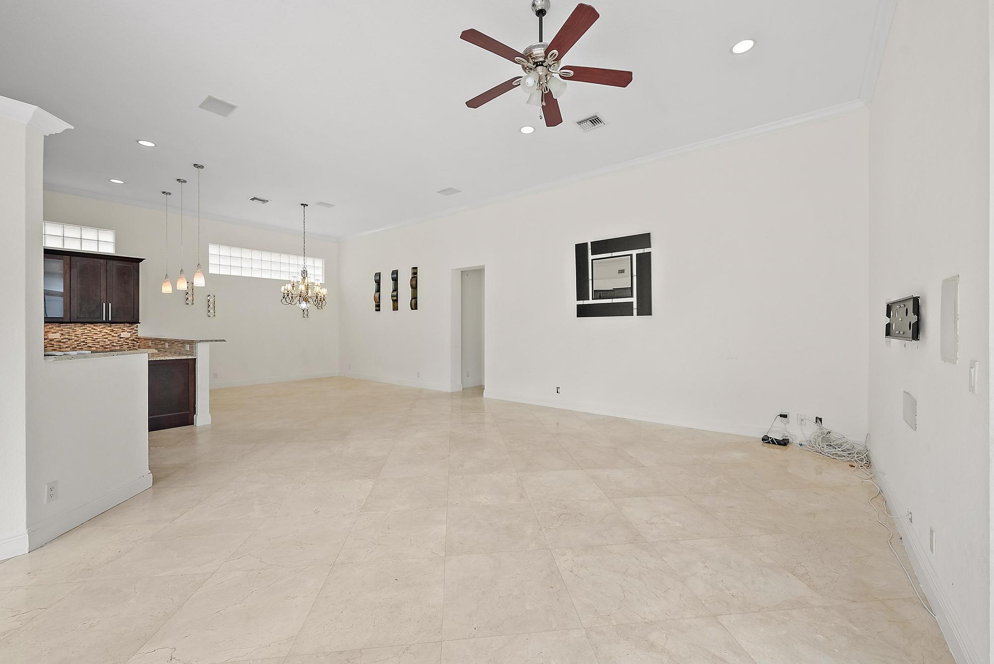 6612 Northwest 23rd Terrace Boca Raton, FL 33496 - Photo 8 of 20 a view of a kitchen with a sink and dishwasher a refrigerator with white cabinets