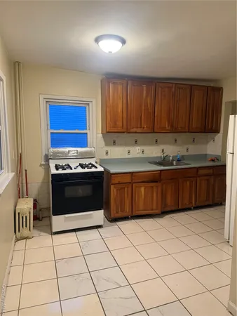 a kitchen with stainless steel appliances granite countertop a stove a sink dishwasher and a refrigerator
