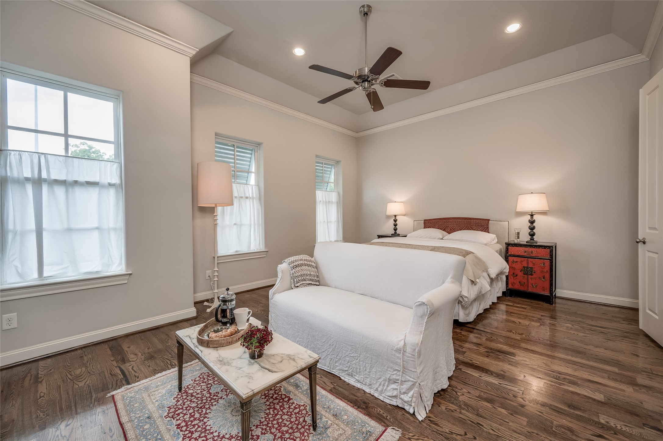 266 East 28th Street Houston, TX 77008 - Photo 9 of 33 a spacious bedroom with a bed a chandelier and a couch