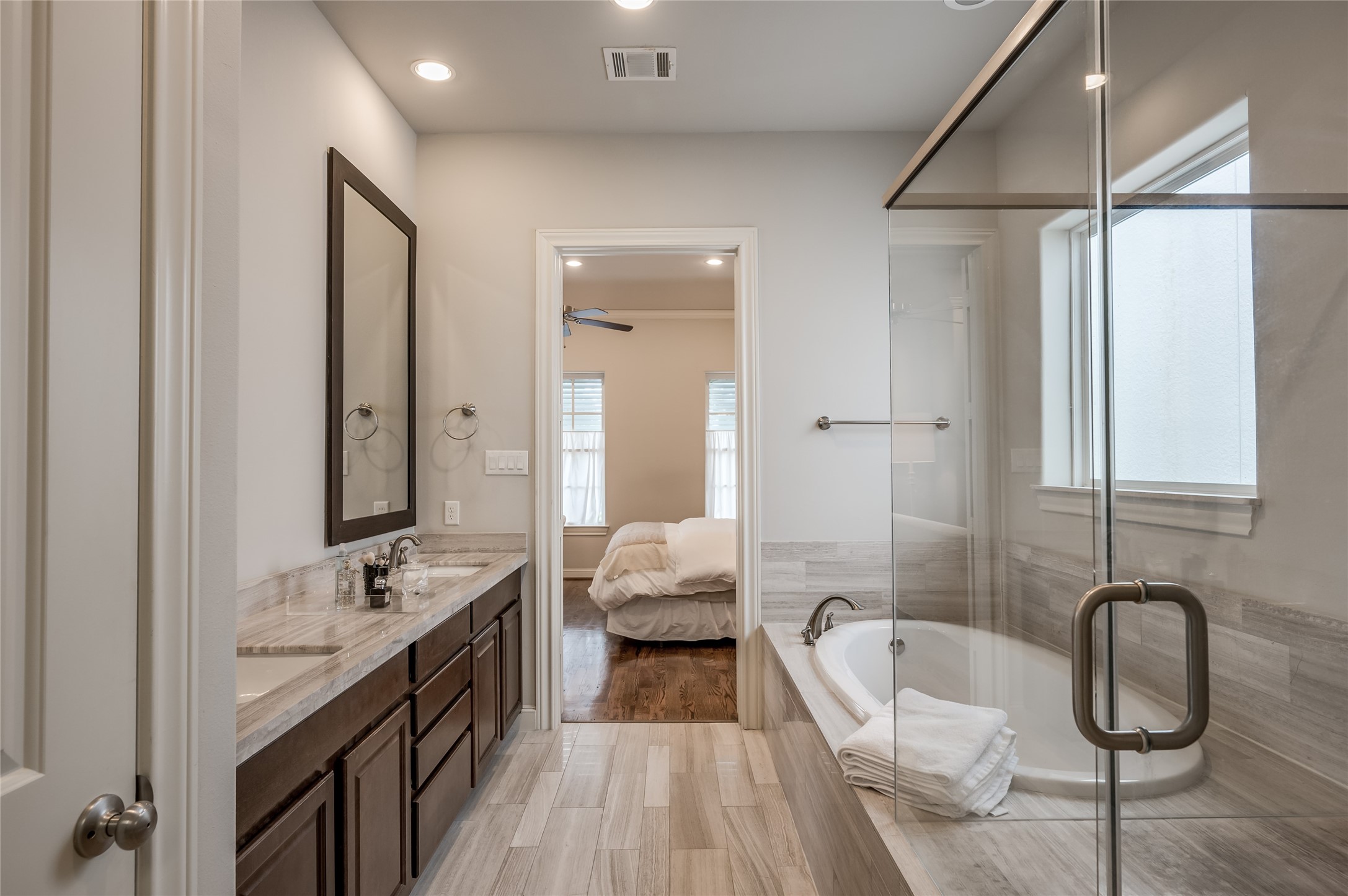 266 East 28th Street Houston, TX 77008 - Photo 13 of 33 a bathroom with a granite countertop tub sink a mirror and a shower