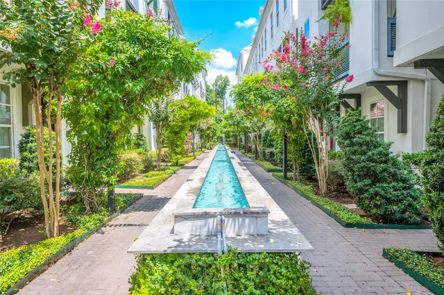 a front view of a house with outdoor seating and flowers