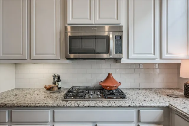 a living room with furniture a dining table and large windows