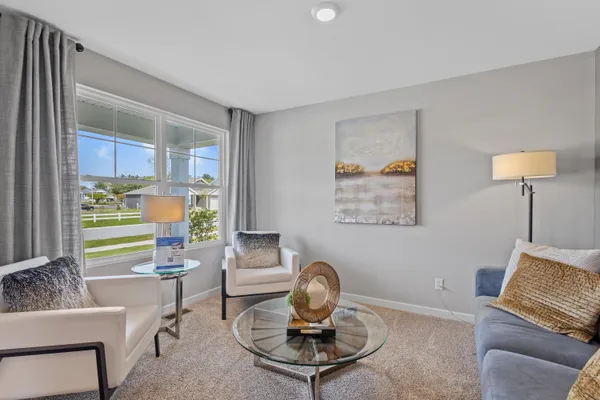 a living room with furniture and a potted plant