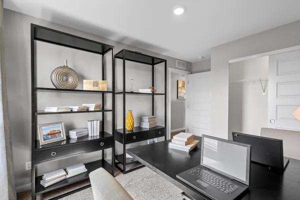 a living room with furniture and a mirror