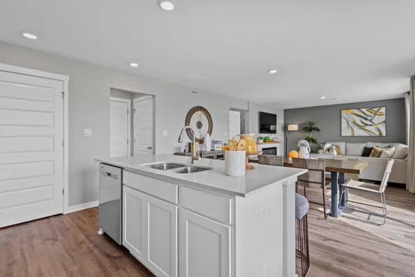 a kitchen with sink and mirror