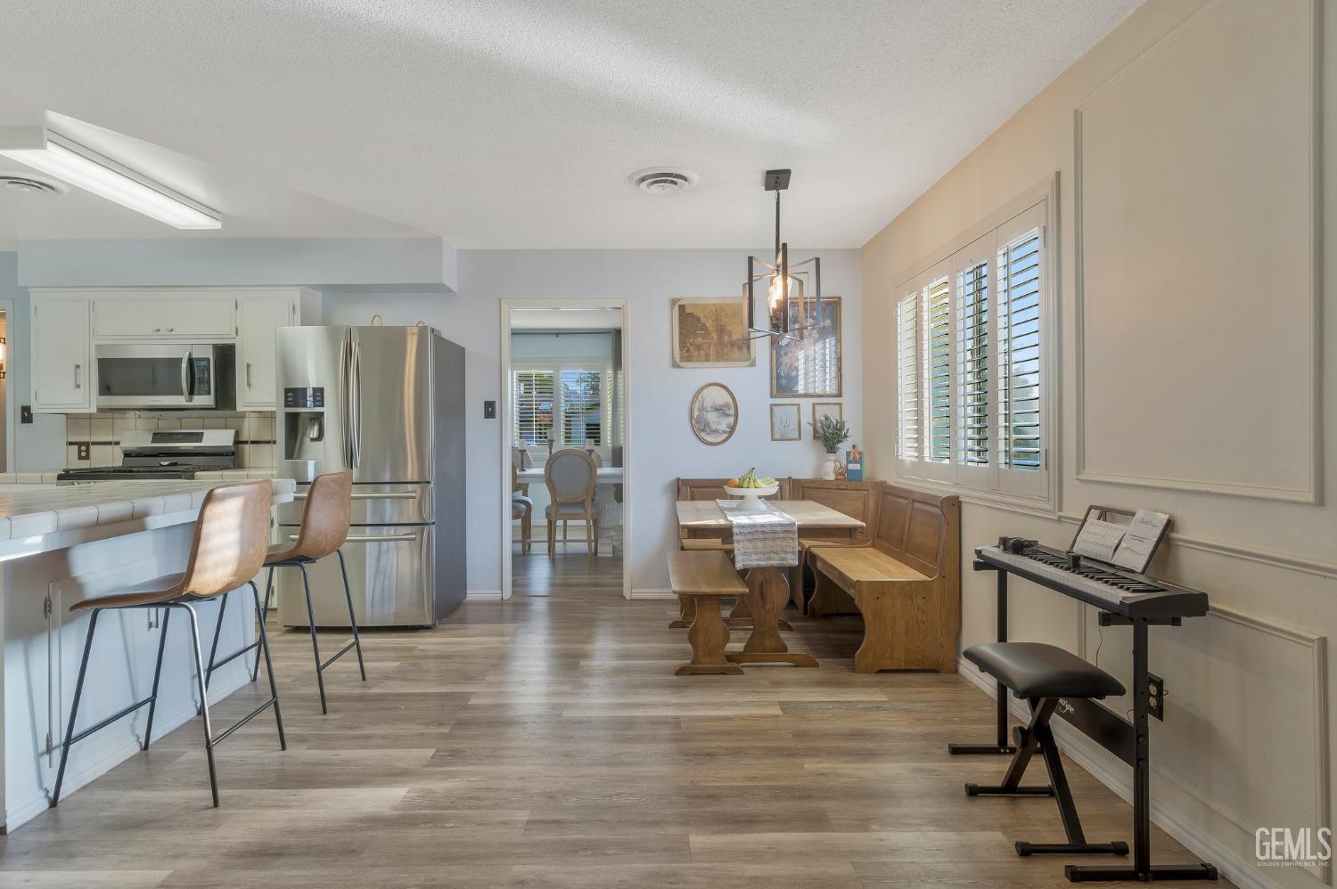 Undisclosed Address Bakersfield, CA 93306 - Photo 12 of 38 a living room with furniture a dining table and a piano table