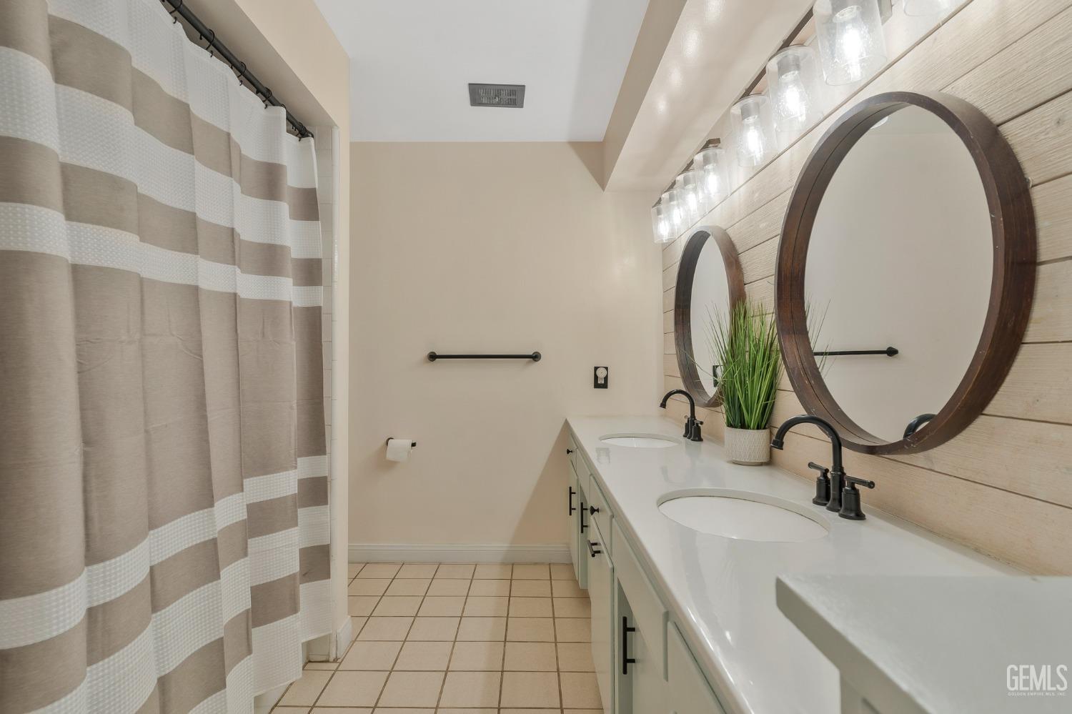 Undisclosed Address Bakersfield, CA 93306 - Photo 15 of 38 a bathroom with a sink and a mirror