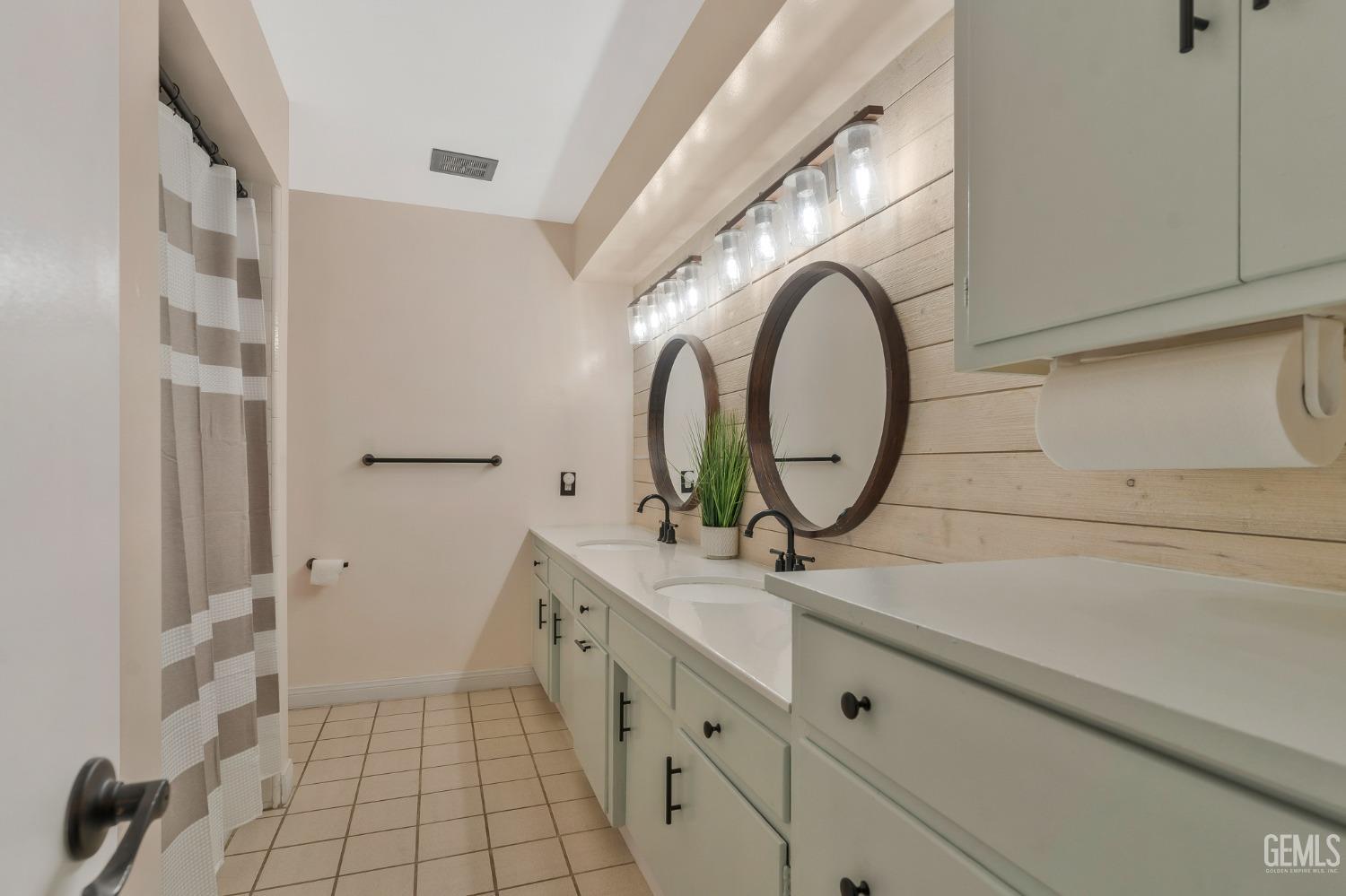Undisclosed Address Bakersfield, CA 93306 - Photo 17 of 38 a bathroom with a sink and a mirror