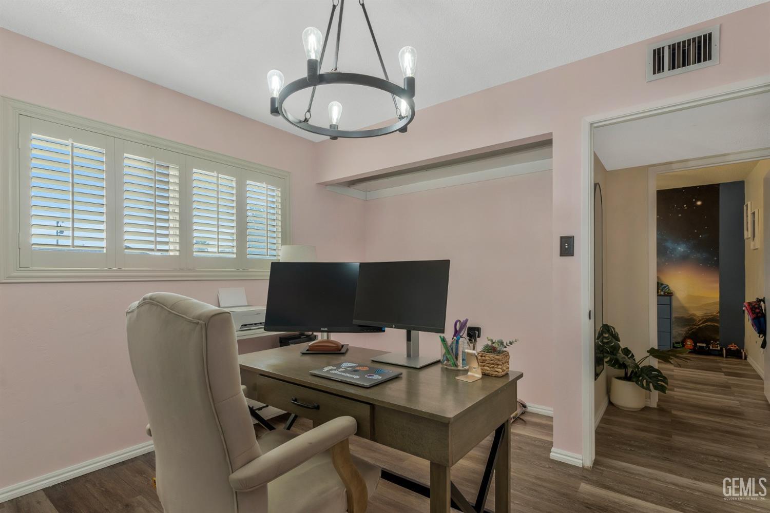 Undisclosed Address Bakersfield, CA 93306 - Photo 19 of 38 a view of a workspace with furniture and a chandelier