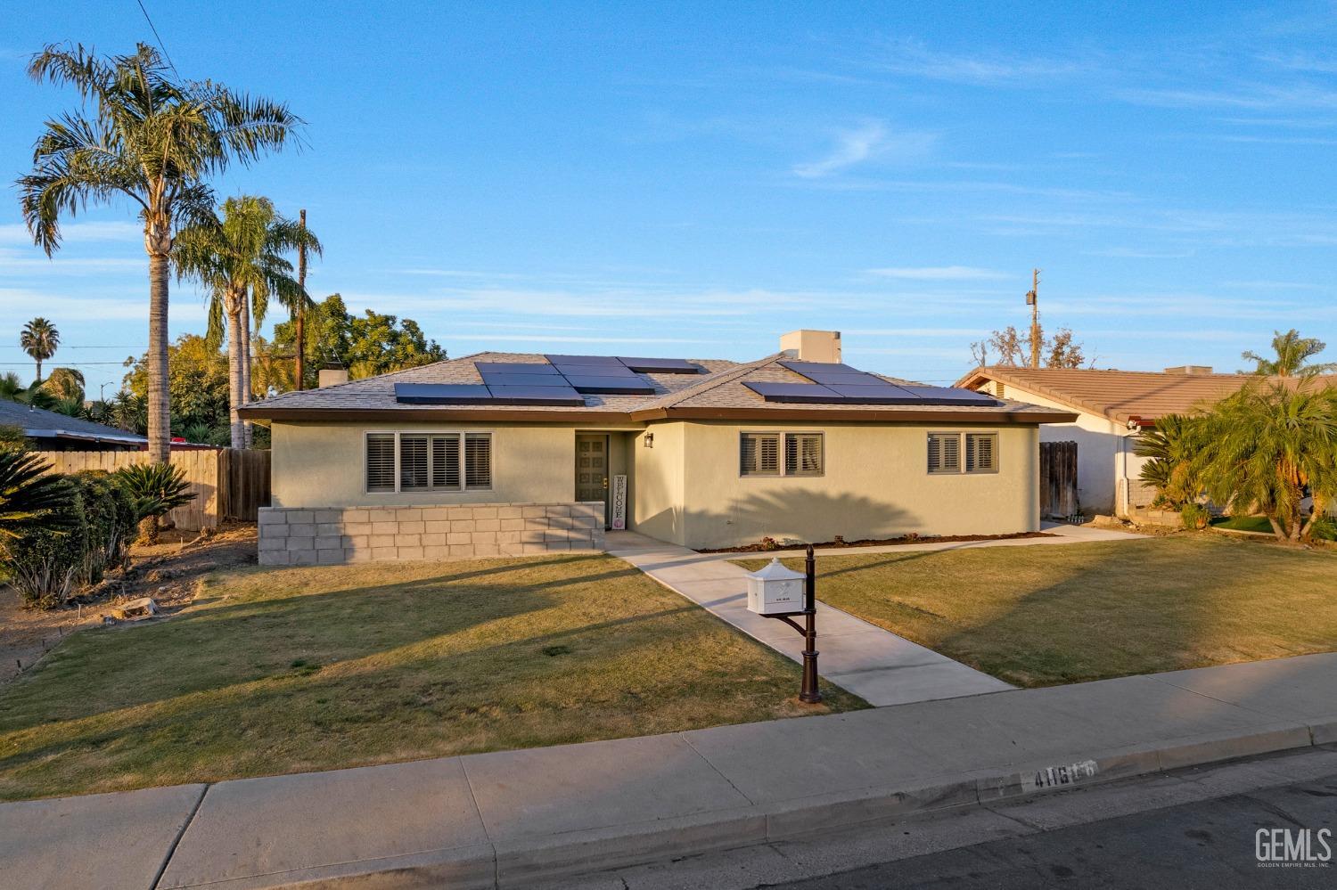 Undisclosed Address Bakersfield, CA 93306 - Photo 2 of 38 a front view of a house with garden