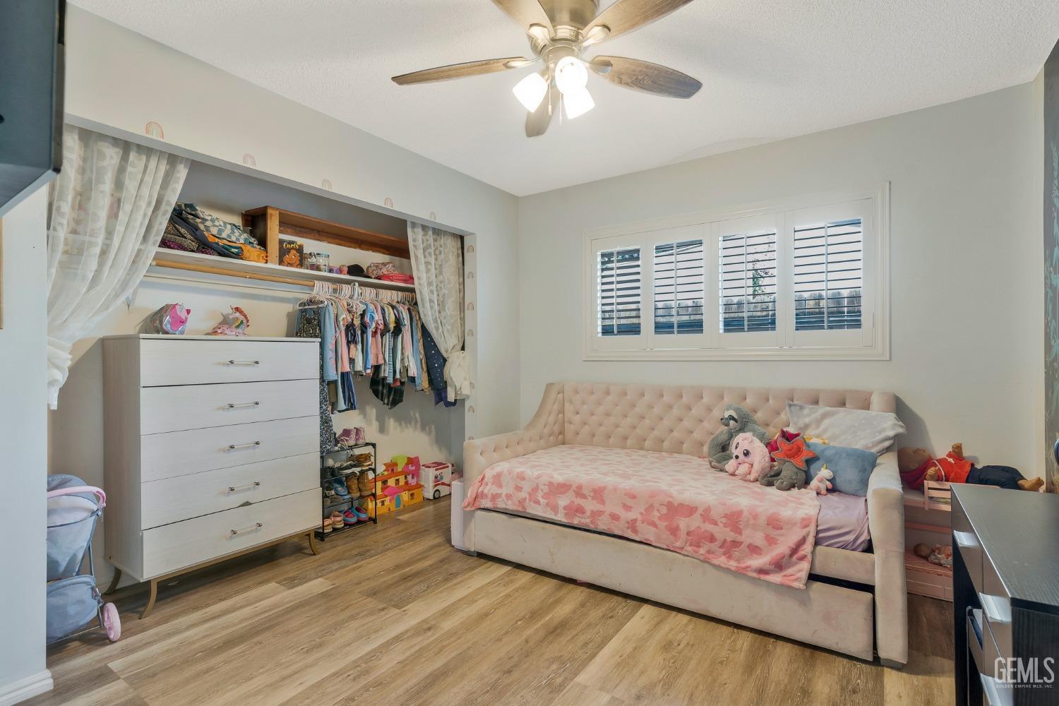 Undisclosed Address Bakersfield, CA 93306 - Photo 22 of 38 a living room with furniture and a baby crib
