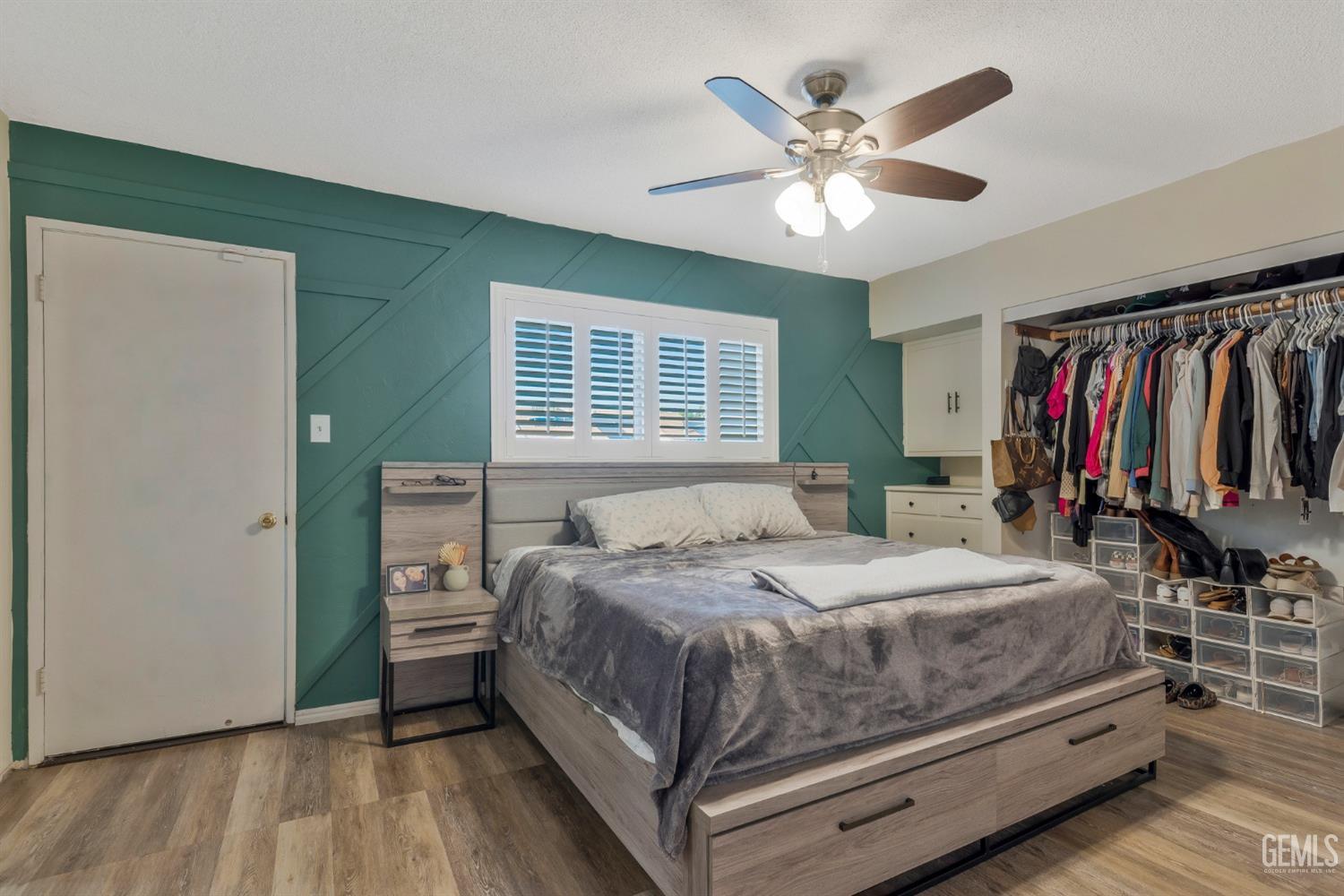 Undisclosed Address Bakersfield, CA 93306 - Photo 23 of 38 a bedroom with a bed and a chandelier