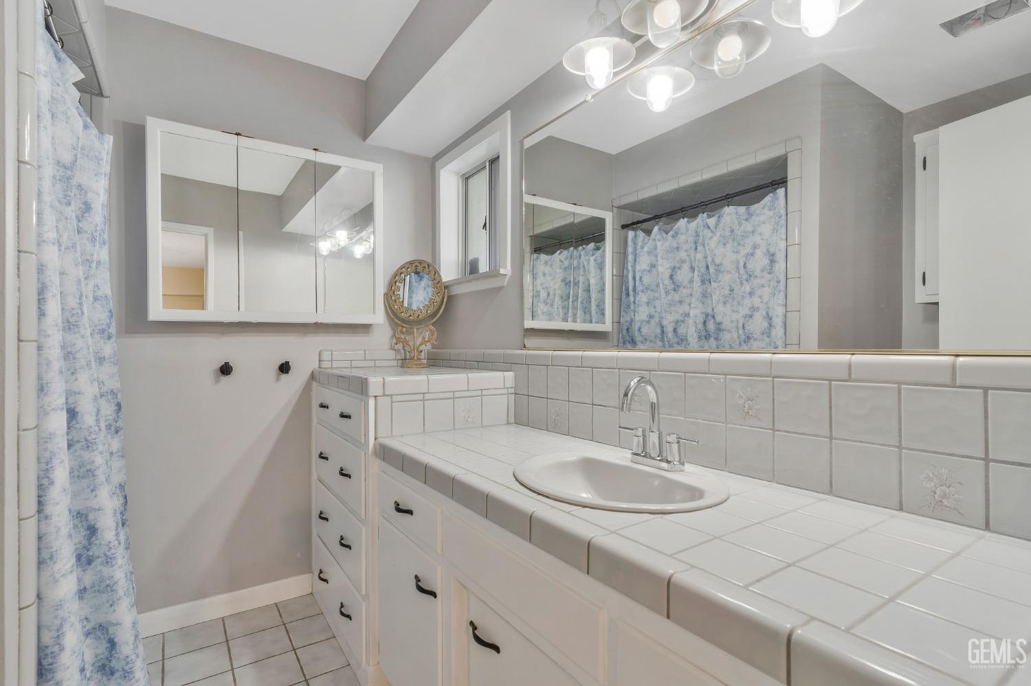 Undisclosed Address Bakersfield, CA 93306 - Photo 25 of 38 a bathroom with a sink and a mirror