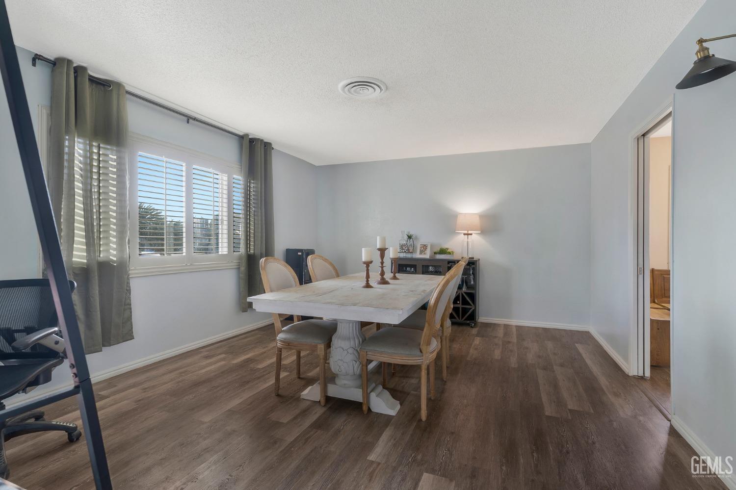 Undisclosed Address Bakersfield, CA 93306 - Photo 6 of 38 a view of a dining room with furniture window and wooden floor